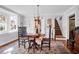 Cozy dining room with a vintage chandelier, hardwood floors and staircase access at 41 Berkeley Rd, Charleston, SC 29407