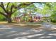 Classic brick home features a charming carport with an upper level balcony and meticulously landscaped grounds at 41 Berkeley Rd, Charleston, SC 29407
