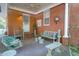 Inviting front porch featuring brick walls, hanging swing, and cozy seating area at 41 Berkeley Rd, Charleston, SC 29407