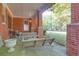 Charming front porch with brick columns and a swing, creating a relaxing outdoor space at 41 Berkeley Rd, Charleston, SC 29407