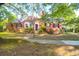 Charming brick home features a well-manicured lawn, a classic brick facade and mature trees at 41 Berkeley Rd, Charleston, SC 29407