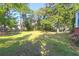Spacious front yard of a classic home featuring mature trees and lush green grass at 41 Berkeley Rd, Charleston, SC 29407