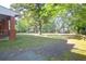 A brick path leads to a lush front yard with mature trees and view of houses down street at 41 Berkeley Rd, Charleston, SC 29407