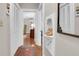 Hallway with hardwood floors, white walls, and a vintage telephone nook at 41 Berkeley Rd, Charleston, SC 29407