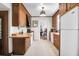 Traditional kitchen featuring wood cabinets, white appliances, and tile flooring at 41 Berkeley Rd, Charleston, SC 29407