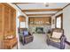Charming living room featuring beamed ceilings, brick fireplace, tiled floor, and cozy seating at 41 Berkeley Rd, Charleston, SC 29407