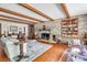 Open-concept living room with brick fireplace, hardwood floors, and comfortable furniture at 41 Berkeley Rd, Charleston, SC 29407