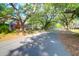 A quaint red brick home sits on a tree-lined street, offering a picturesque setting and curb appeal at 41 Berkeley Rd, Charleston, SC 29407