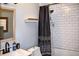 Cozy bathroom featuring subway tiles in the shower, a dark shower curtain, and an adjacent light wood vanity at 416 Jelly Rolls Rd, Moncks Corner, SC 29461