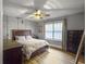 Well-lit bedroom with wood plank flooring, a ceiling fan, and stylish furnishings at 416 Jelly Rolls Rd, Moncks Corner, SC 29461