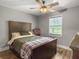 Comfortable bedroom with wooden floors, ceiling fan, and a decorative wooden bed frame at 416 Jelly Rolls Rd, Moncks Corner, SC 29461