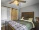 Comfortable bedroom featuring a ceiling fan and a sliding barn door, blending rustic and modern elements at 416 Jelly Rolls Rd, Moncks Corner, SC 29461