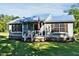 Charming home with lush front lawn, American flag, and well-maintained landscaping at 416 Jelly Rolls Rd, Moncks Corner, SC 29461