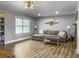 This large living room has wood flooring, big windows for lots of light, and comfortable seating at 416 Jelly Rolls Rd, Moncks Corner, SC 29461