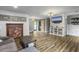 The comfortable living room features a brick fireplace, wood flooring, and access to the back yard at 416 Jelly Rolls Rd, Moncks Corner, SC 29461
