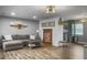 Spacious living room featuring wood flooring, a comfortable couch, a brick fireplace and access to the kitchen at 416 Jelly Rolls Rd, Moncks Corner, SC 29461