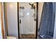 Nicely tiled walk-in shower with bronze trim, river rock floor, and convenient shampoo storage shelves at 416 Jelly Rolls Rd, Moncks Corner, SC 29461