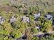 An aerial view showcases homes surrounded by trees, near a marsh at 418 Snowy Egret Ln, Kiawah Island, SC 29455