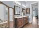 Bathroom with a large vanity with marble countertop, decorative mirrors, and modern lighting at 418 Snowy Egret Ln, Kiawah Island, SC 29455