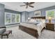 This bedroom features a ceiling fan, carpet and a wooden bed with under-bed storage and blue walls at 418 Snowy Egret Ln, Kiawah Island, SC 29455