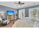 Bedroom featuring wood floors, neutral walls, ceiling fan, plantation shutters, and balcony access at 418 Snowy Egret Ln, Kiawah Island, SC 29455