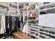 Walk-in closet with custom shelving, hanging rods, drawers, and shoe storage at 418 Snowy Egret Ln, Kiawah Island, SC 29455