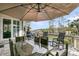 This deck features assorted furniture including rocking chairs and tables with an open view and large umbrella at 418 Snowy Egret Ln, Kiawah Island, SC 29455