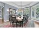 Dining room with a large wood table, chandelier, and windows with wooden shutters at 418 Snowy Egret Ln, Kiawah Island, SC 29455