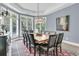 Bright dining room with a large wood table, chandelier, and windows with wood shutters at 418 Snowy Egret Ln, Kiawah Island, SC 29455
