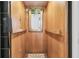 Interior of wood-paneled elevator with mirror and safety features at 418 Snowy Egret Ln, Kiawah Island, SC 29455