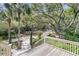 Exterior daytime shot from the deck of the property surrounded by dense trees and palms at 418 Snowy Egret Ln, Kiawah Island, SC 29455