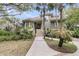 Attractive exterior view of home featuring mature landscaping and stairs to porch at 418 Snowy Egret Ln, Kiawah Island, SC 29455