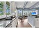 Open kitchen and living area with granite countertops, hardwood floors, and outdoor views at 418 Snowy Egret Ln, Kiawah Island, SC 29455