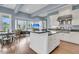 Open-concept kitchen with stainless steel appliances, a center island, and seamless flow into the living area at 418 Snowy Egret Ln, Kiawah Island, SC 29455