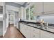 Kitchen featuring granite counters, white cabinets, stainless steel appliances, and hardwood floors at 418 Snowy Egret Ln, Kiawah Island, SC 29455