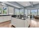 Spacious kitchen with an island, white cabinets, and windows, ideal for cooking and gathering at 418 Snowy Egret Ln, Kiawah Island, SC 29455