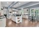Bright kitchen featuring white cabinets, granite counters, and stainless-steel appliances, with an adjacent breakfast table at 418 Snowy Egret Ln, Kiawah Island, SC 29455