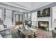 Elegant living room featuring fireplace, hardwood floors, and natural light at 418 Snowy Egret Ln, Kiawah Island, SC 29455