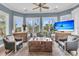 Elegant living room featuring tray ceilings, large windows, and comfortable seating, perfect for relaxing at 418 Snowy Egret Ln, Kiawah Island, SC 29455