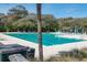 Large outdoor pool surrounded by lush greenery, chairs and tables offer plenty of space at 418 Snowy Egret Ln, Kiawah Island, SC 29455