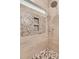 Elegant shower with natural stone tile, a built-in niche, and a mosaic tile floor at 418 Snowy Egret Ln, Kiawah Island, SC 29455