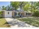 Single story brick home with lush front lawn and a paved driveway leading to the entrance at 4412 Garwood Dr, Ladson, SC 29456