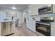 Updated kitchen boasts stainless steel appliances, bright white cabinets and countertop seating at 4412 Garwood Dr, Ladson, SC 29456
