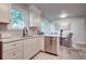 Bright eat-in kitchen features updated cabinets, stainless steel appliances, stone countertops and a modern sink at 4412 Garwood Dr, Ladson, SC 29456