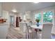 Bright kitchen and dining area with white cabinetry, stainless steel appliances, and modern finishes at 4412 Garwood Dr, Ladson, SC 29456