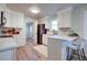 Modern kitchen with white cabinets, white countertops, stainless steel appliances and stylish barstool seating at 4412 Garwood Dr, Ladson, SC 29456