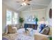 Cozy living room with vaulted ceilings, natural light, comfortable seating, and tasteful decor at 4412 Garwood Dr, Ladson, SC 29456