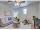 Cozy living room with neutral walls, wood-look floors, ceiling fan, couch and accent chair at 4412 Garwood Dr, Ladson, SC 29456