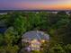 Back of house at dusk surrounded by lush greenery, and distant river at 4952 Steeplechase Ln, Hollywood, SC 29449