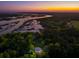 Serene waterfront property surrounded by lush trees, offering stunning sunset views over the river at 4952 Steeplechase Ln, Hollywood, SC 29449